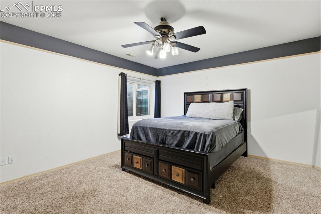 Bedroom with carpet floors and a ceiling fan