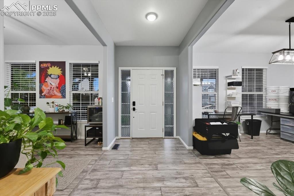 To the right you can enjoy the open dining area that accommodates a park of 12.  To the left is a formal sitting area area or flex space…think pool table or library.