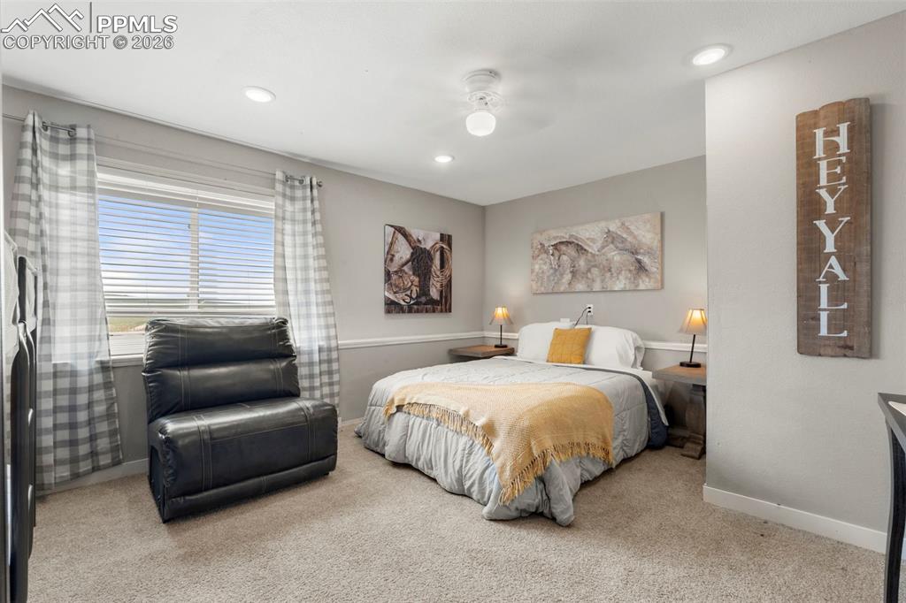 Bedroom with light colored carpet, a ceiling fan, and recessed lighting