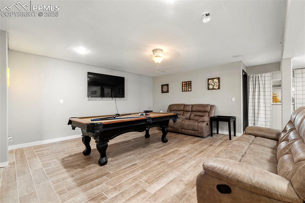 Playroom with billiards table and wood finish floors