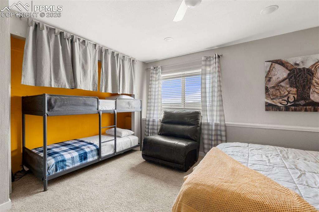 Bedroom featuring light colored carpet and a ceiling fan