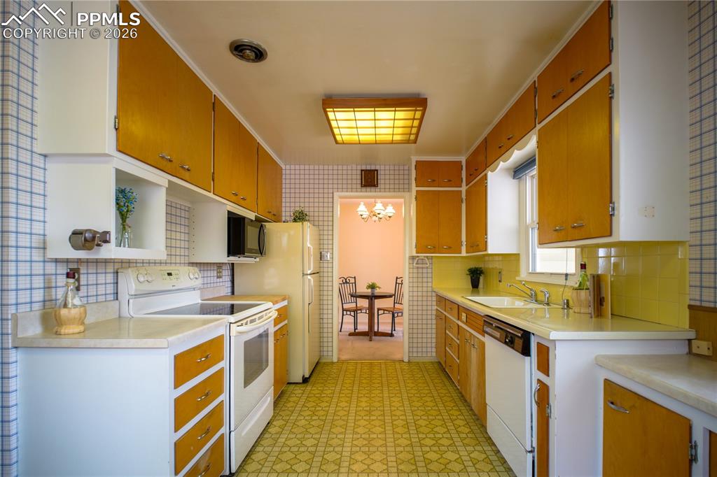 Gally style kitchen offers great space and natural light. Mid-century charm is still here. It even has an "old school" pencil sharpener on the wall!