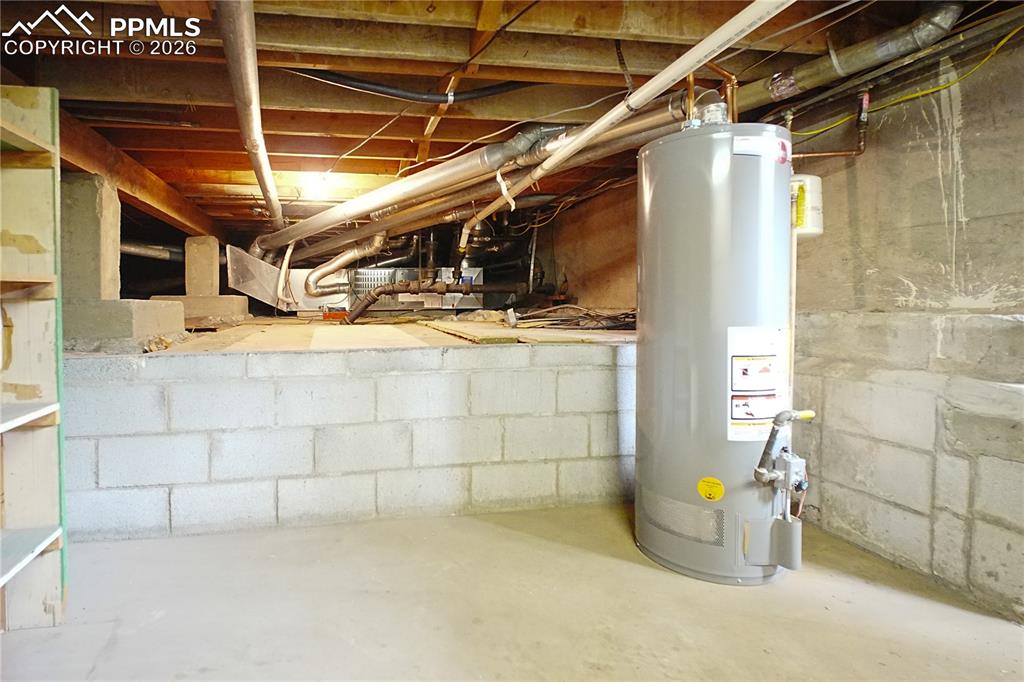A newer water heater located in the unfinished basement area