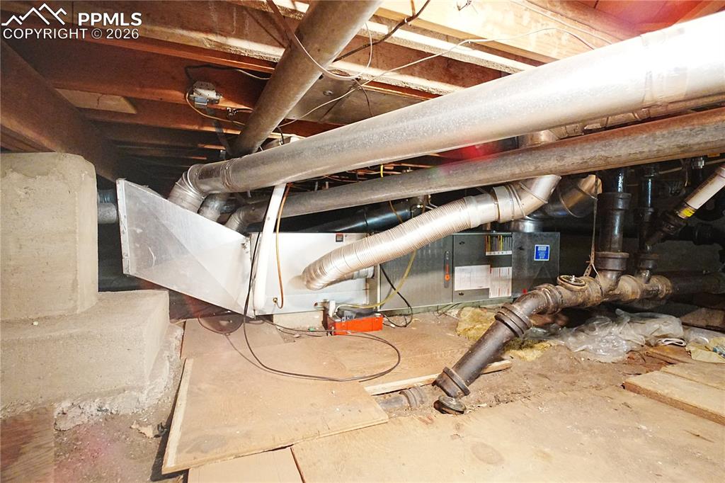 Furnace access in the crawlspace is accessed from the basement storage area