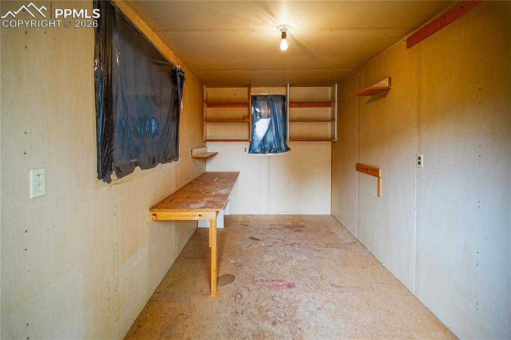 A 15x8 storage shed with electricity, includes two windows for natural light and built-in shelves and table perfect for all types of projects