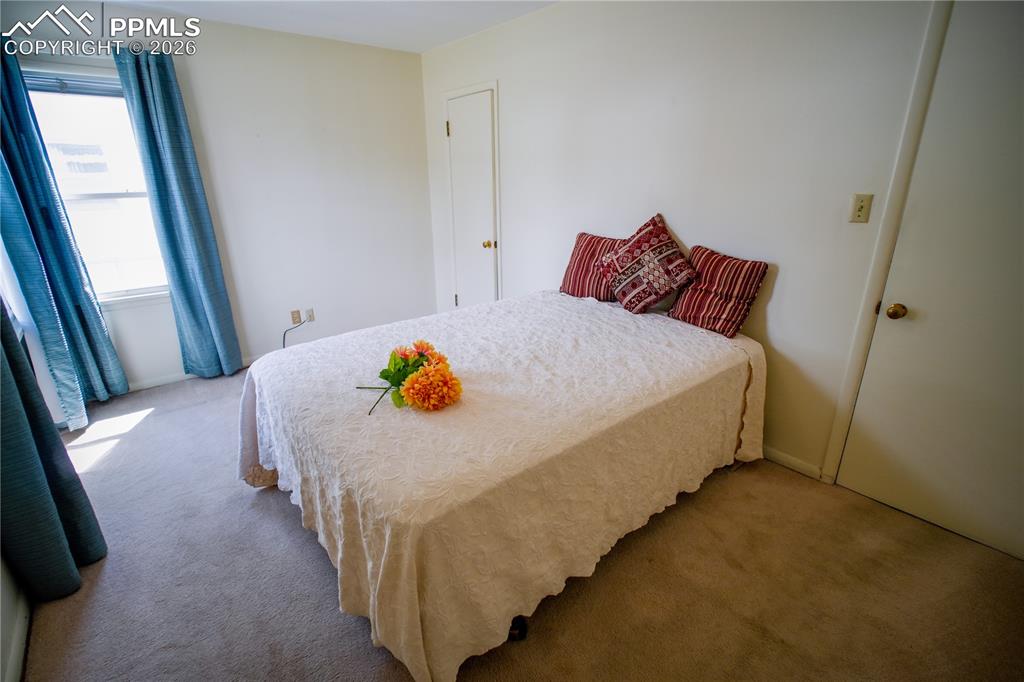 The largest of two bedrooms and offers great natural light. Original wood floors lie beneath the carpet