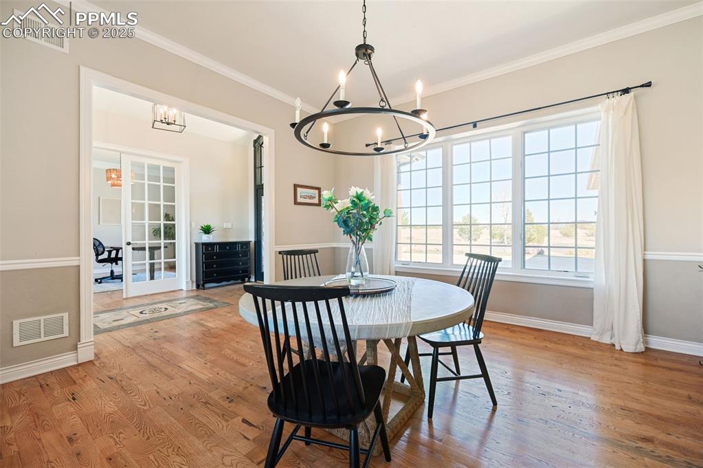 This formal dining area has a huge window at the front of the house and a generous doorway to the living area.