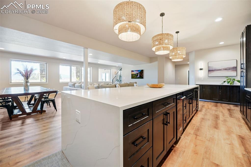 A sleek quartz waterfall countertop is so inviting for hanging out with snacks and playing games.