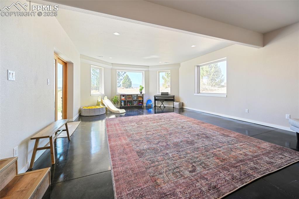 In the walkout basement, a sunroom provides one access to the stamped concrete patio outside.