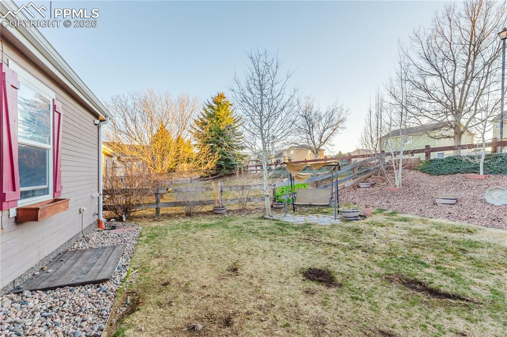 Fenced backyard featuring a patio