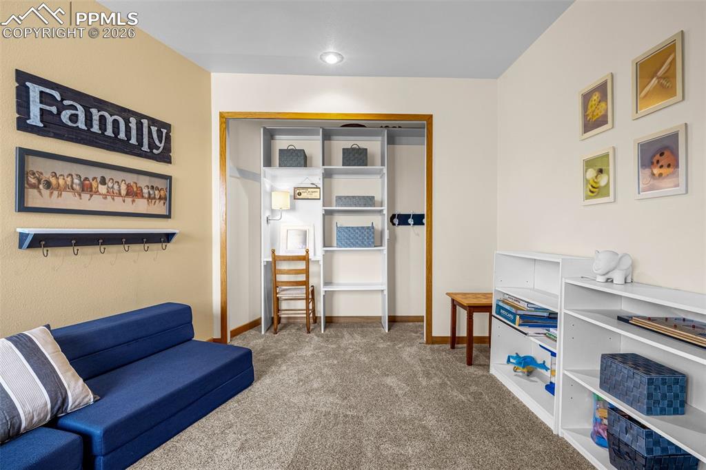 Sitting room with carpet and baseboards