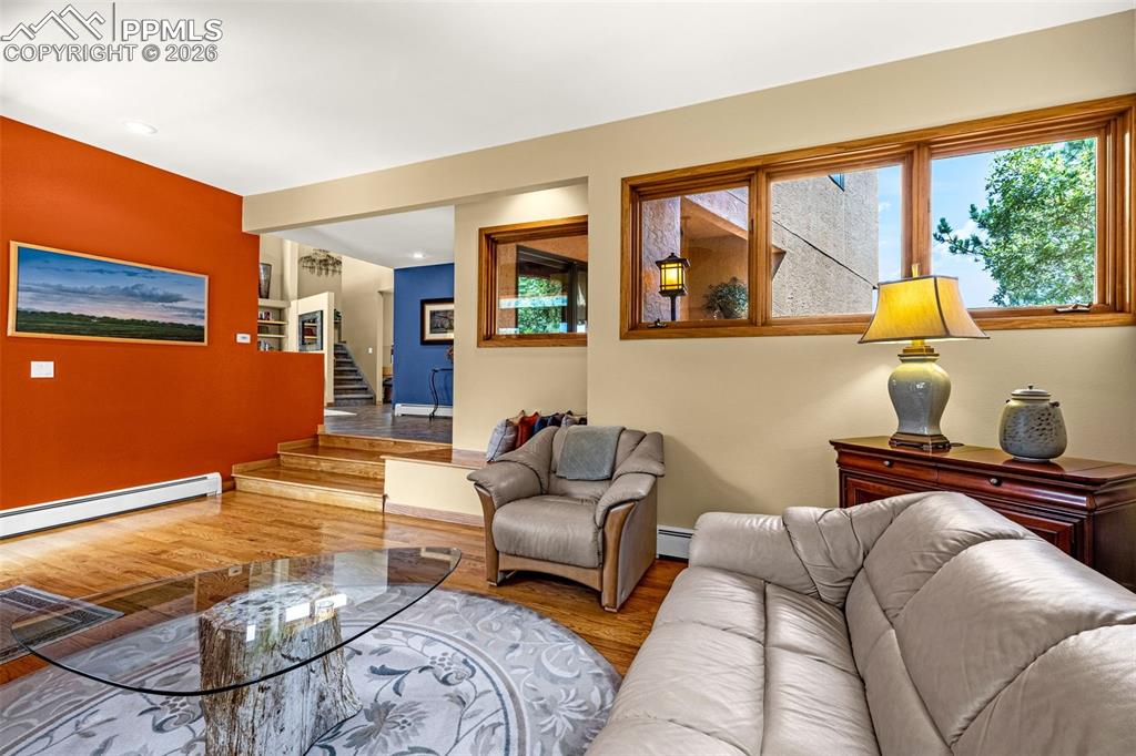 Living room with wood finished floors and baseboard heating