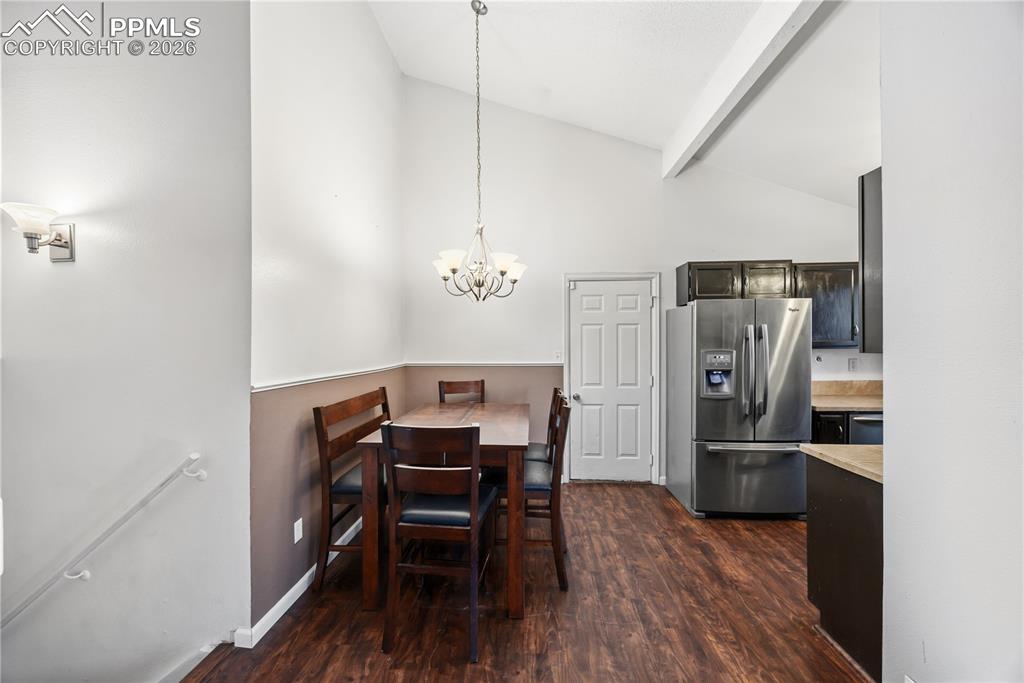 Eat-in kitchen with a spacious dining area with attractive light fixture.