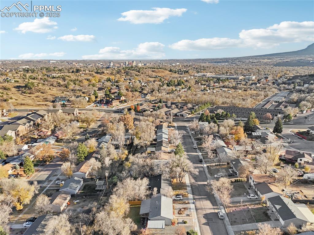 House is in the center of the foreground of this quiet, west-side neighborhood