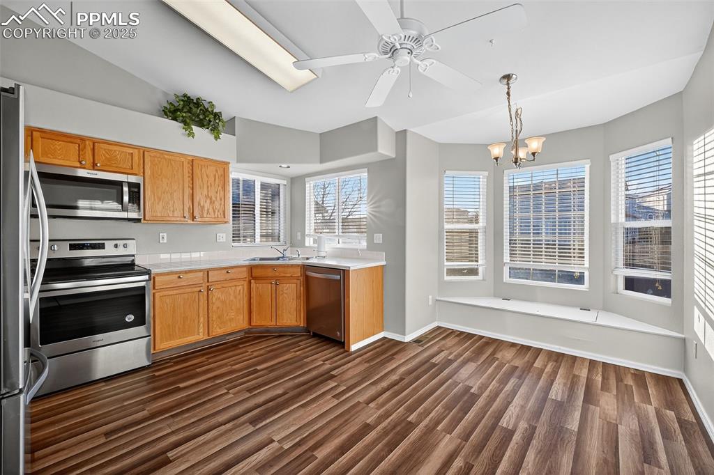 Eat In Kitchen with a really neat bay window seating area that double as storage area!!! All Plantation Blinds