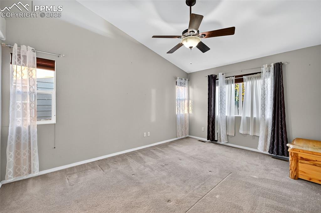 Large primary suite, with vaulted ceiling, fan, bright widows on main floor. 