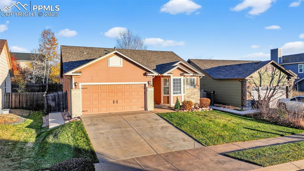 View of front of house featuring driveway, an attached garage, brick siding, and a shingled roof