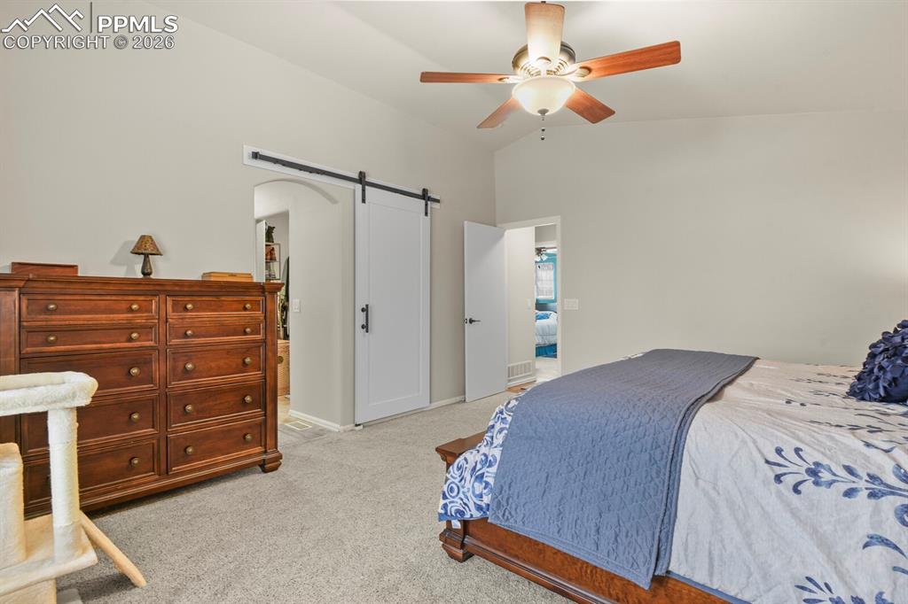 Barn door leading into the primary en suite bathroom