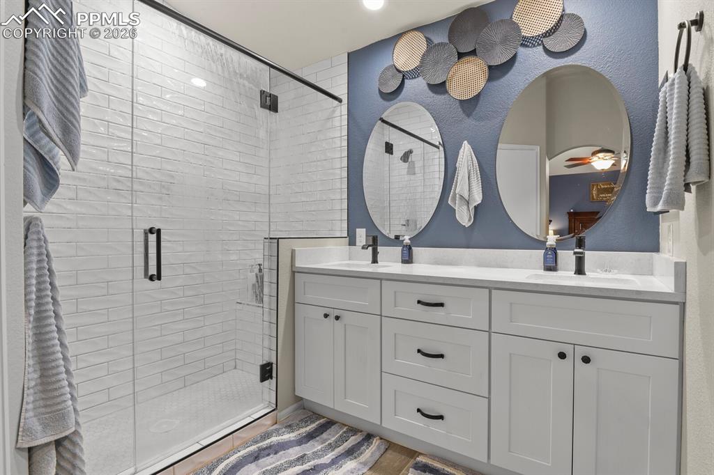 Large walk in shower in the primary bathroom with double sinks