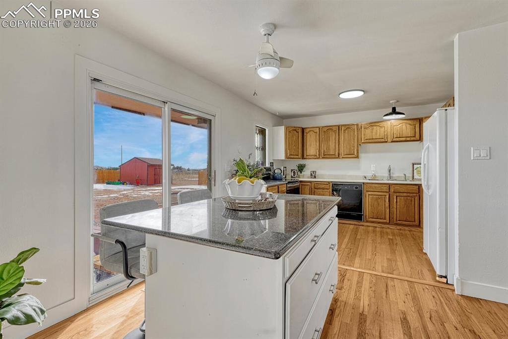 Kitchen on the south side of the house. Granite toped island and sliders to huge backyard
