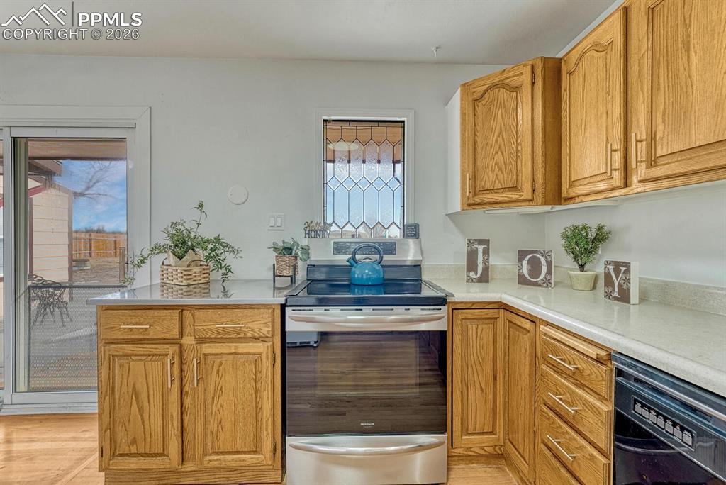 Kitchen with leaded glass window, sliders to backyard on the left