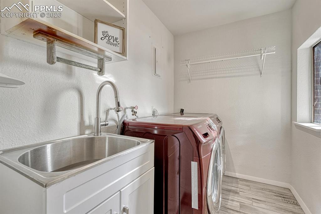 Laundry room with sink and window