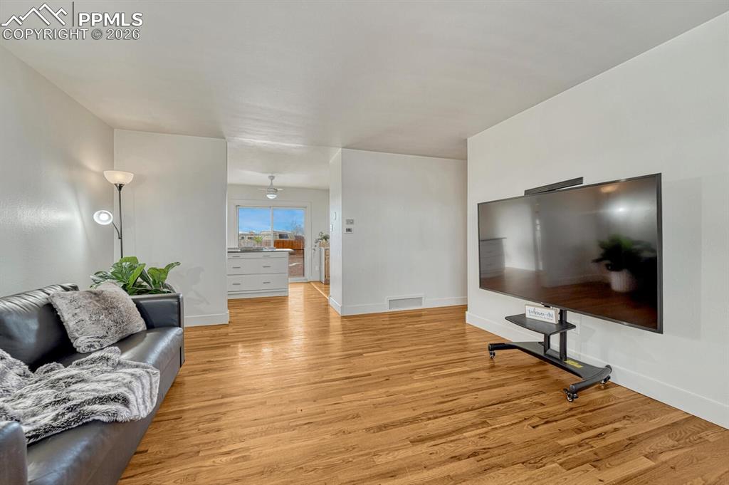 Living room, opens to kitchen with walkout to backyard.