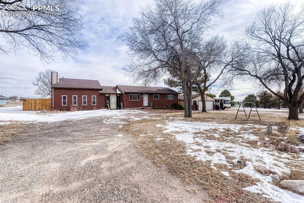 Circular Driveway with huge detached garage with attached shed and workroom.