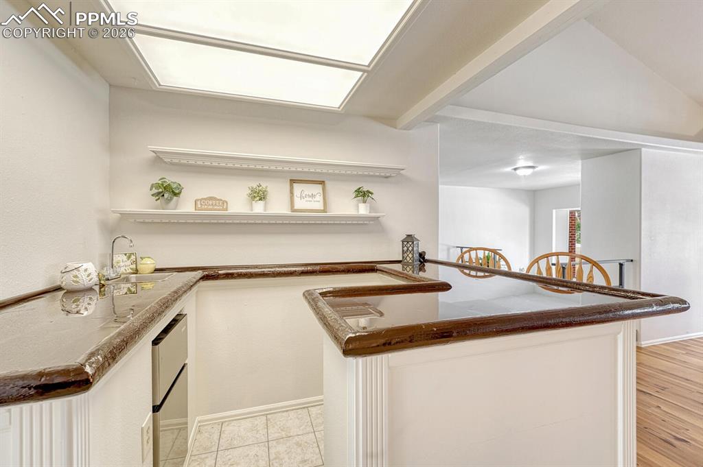 Wet bar with small fridge and sink