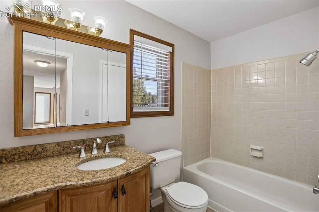 Bathroom featuring vanity and shower / washtub combination