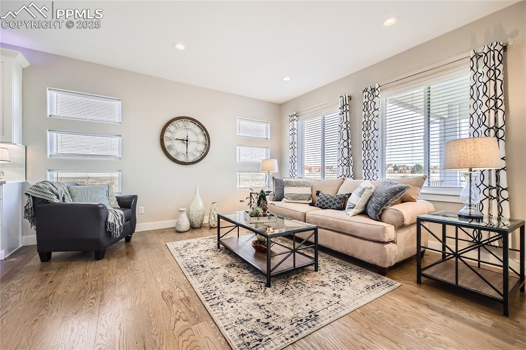 This wonderful living room offers many windows that overlook the home's acreage. It's open to the kitchen and dining area, too!