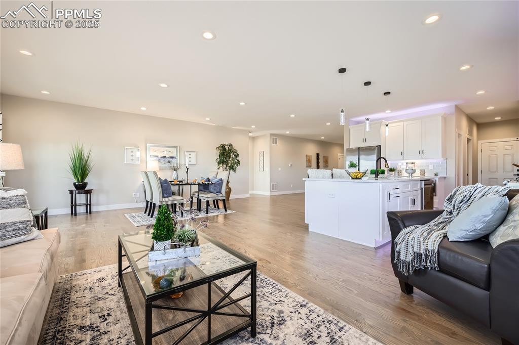 The large open area boasts a beautiful living room, and an expansive dining area with lots of space to accommodate your guests for all your gatherings!