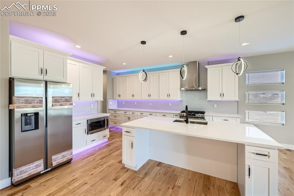 The custom-designed kitchen is a beauty! Notice the cabinet lighting...above, below, and floor. The lights can be different colors, too!