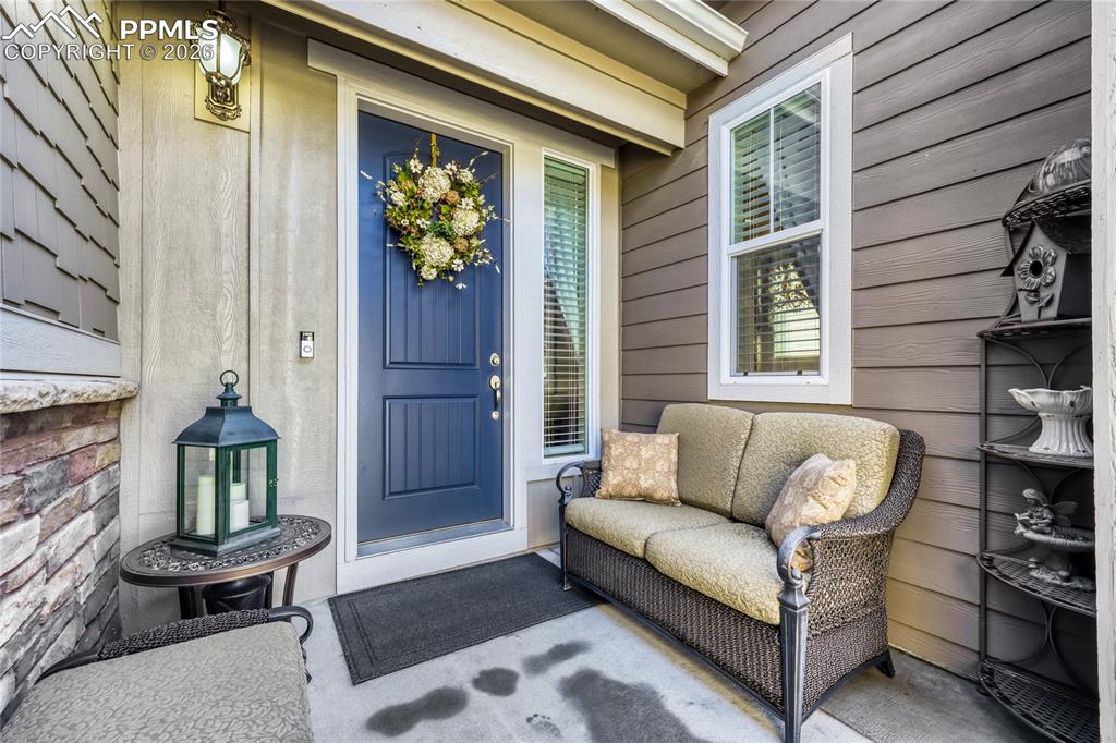 View of spacious exterior entry with charming gate. 