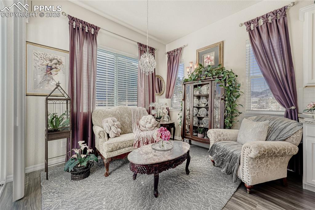 Dining area currently used as a Sitting room featuring suspended lighting. 