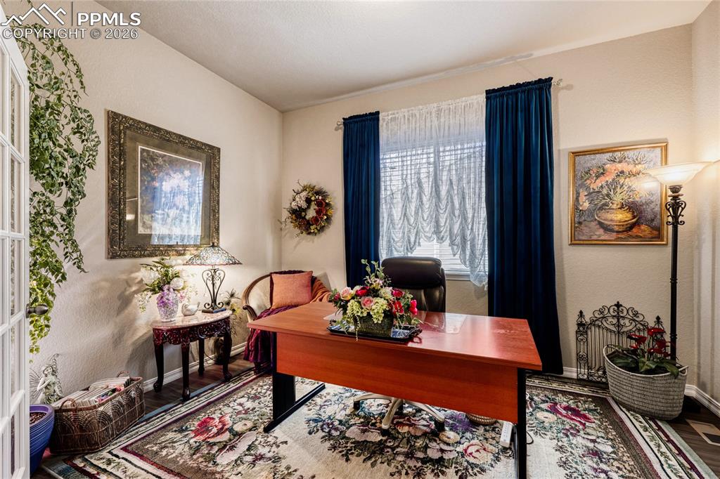 Home office featuring LVP floors, glass french doors. 