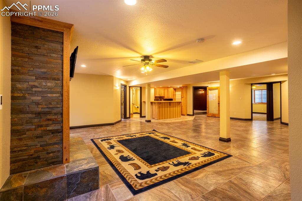 Basement family room with gas fireplace and tv stays
