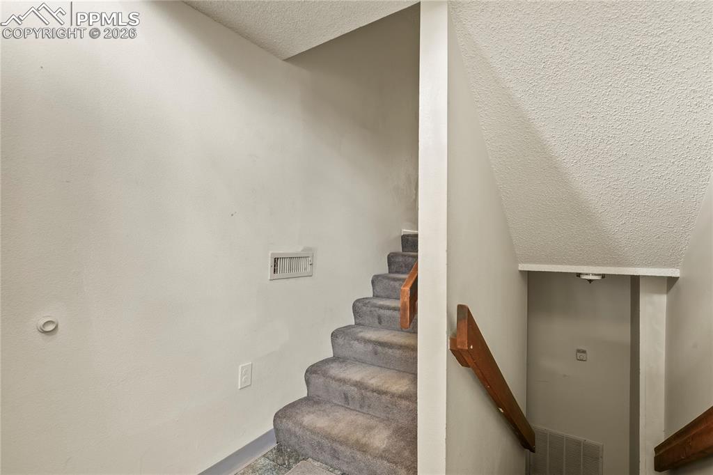 Front entry. Stairs to garage and main level