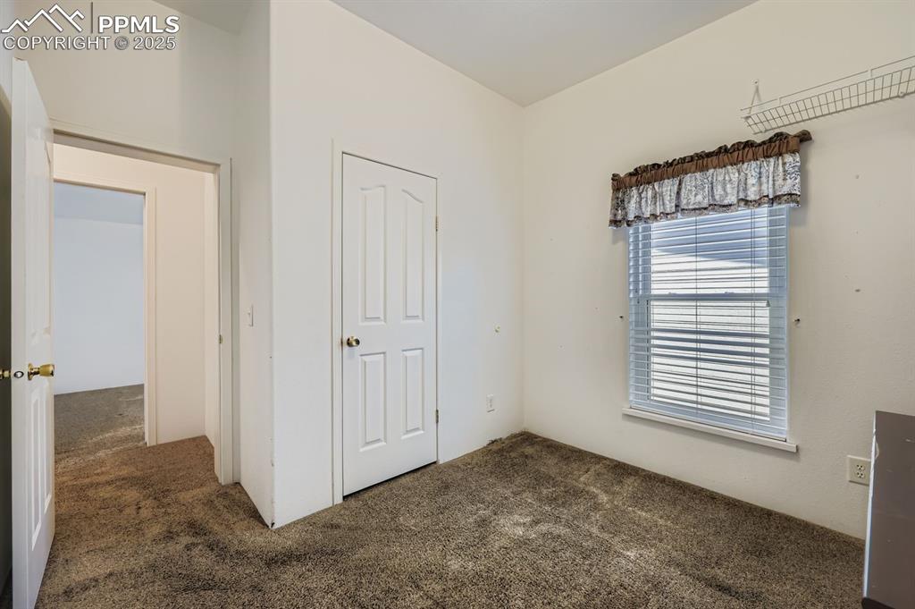 Unfurnished bedroom featuring carpet floors and a closet