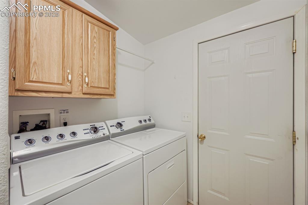 Laundry room with cabinet space and washing machine and clothes dryer