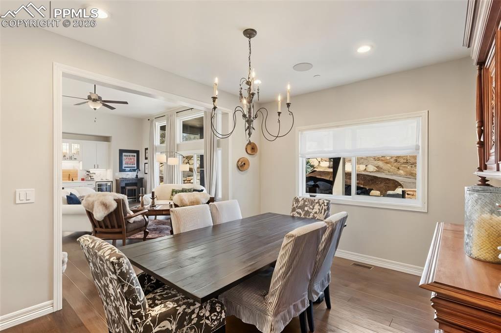 The formal dining room acts as a transitional space, borrowing natural light from the great room while maintaining its own intimate, defined atmosphere for hosted dinners
