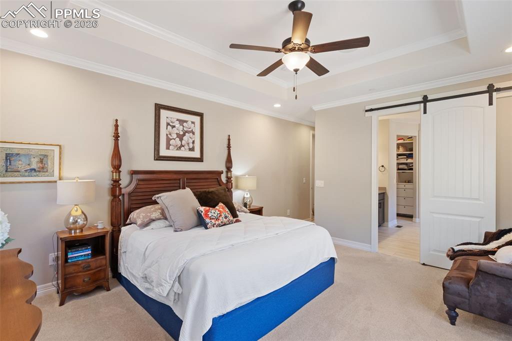  A sliding barn door provides a stylish, space-saving transition from the primary bedroom into the spa-like en-suite, ensuring privacy without sacrificing the room's footprint
