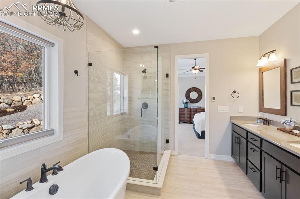 The primary bathroom offers a massive glass-enclosed shower and 60 inch free standing tub
