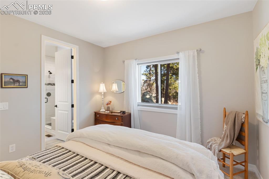 Positioned with immediate access to an adjacent full bathroom, this bedroom operates as a highly functional secondary suite for family or visitors