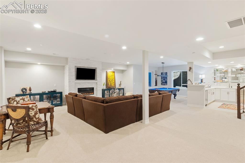 This basement is a host’s dream, intelligently divided into distinct conversational, gaming, and cinematic areas without feeling disjointed