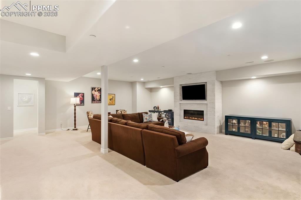 Anchored by a second striking gas fireplace, the basement living space provides a cozy, environment ideal for late-night movie screenings or relaxed winter evenings
