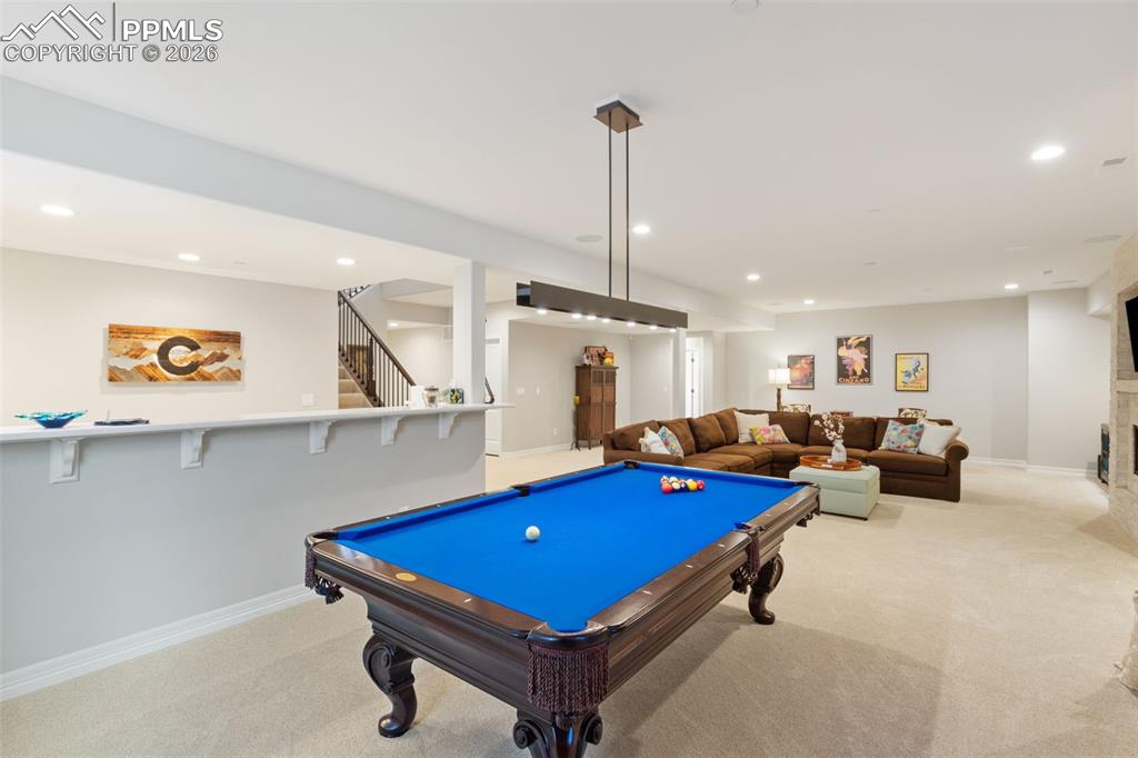 The open flow from the billiards area to the bar and media space allows for dynamic, large-scale entertaining where family and/or guests can mingle freely across different activities
