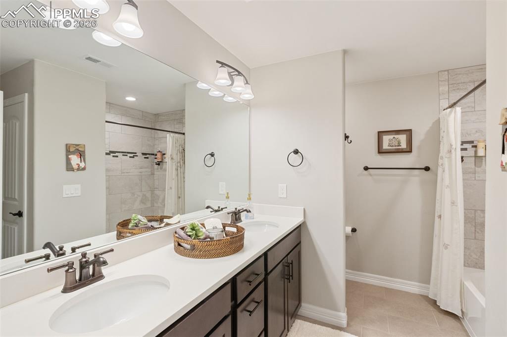 The basement bathroom is appointed with the same level of luxury as the main floors, featuring a double vanity and shower/tub combo
