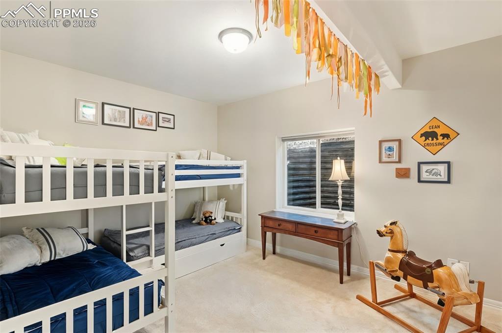Another basement bedroom serves as a high-capacity bunk room, creating a playful and functional retreat for children or grandchildren
