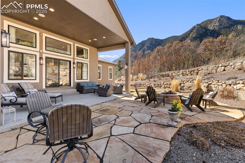 Extending the living space into the outdoors, the covered terrace and custom flagstone patio are crafted for outdoor dining and twilight gatherings around the fire pit
